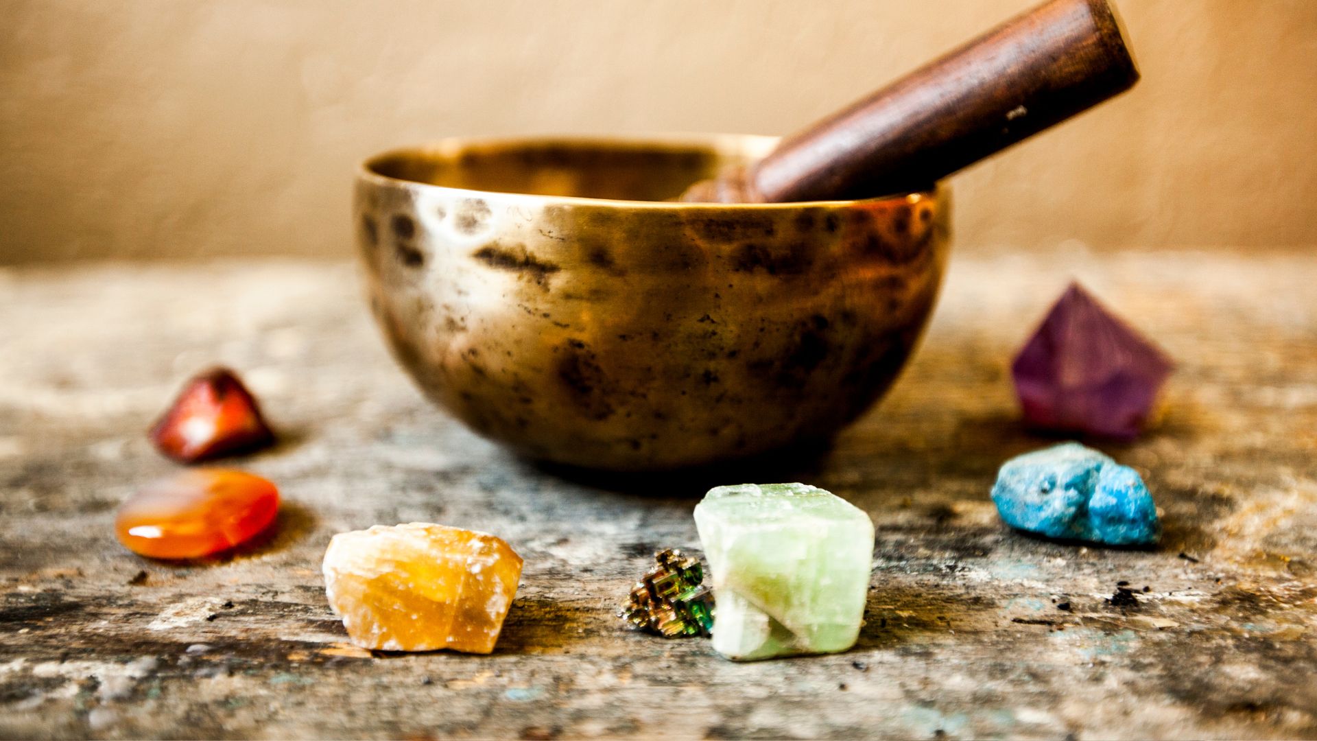 A wooden bowl filled with different colored rocks