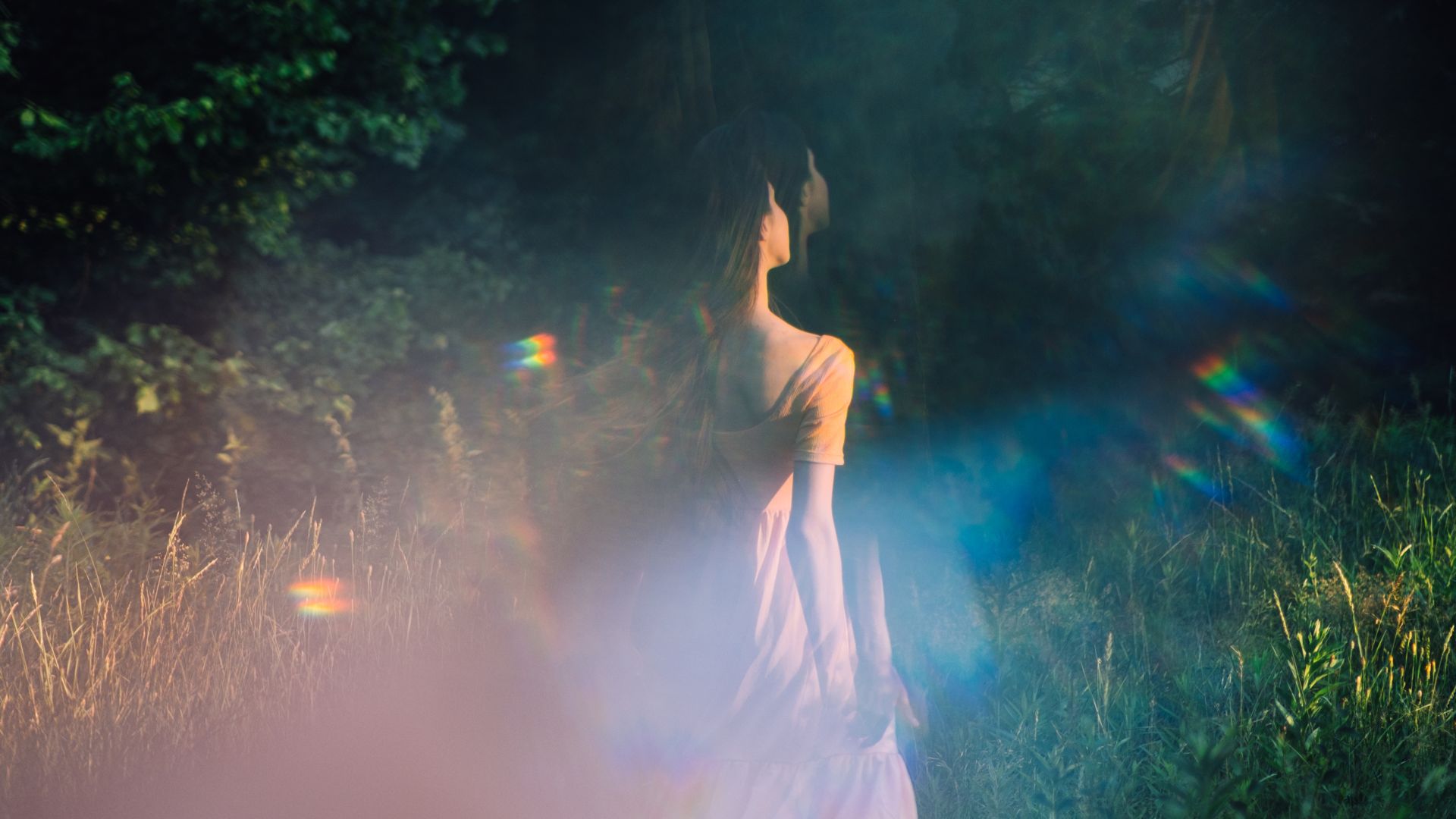 A woman in a white dress standing in a field